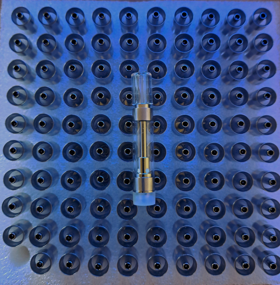 A large number of V10 - PCTG Round Tip -1ml sitting on top of a blue background.